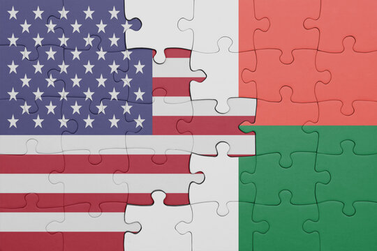 puzzle with the colourful national flag of madagascar and flag of united states of america .