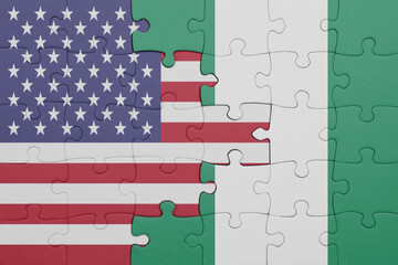puzzle with the colourful national flag of nigeria and flag of united states of america .
