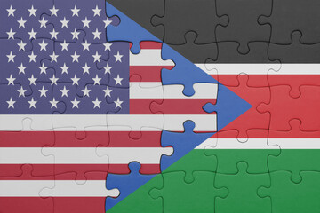 puzzle with the colourful national flag of south sudan and flag of united states of america .