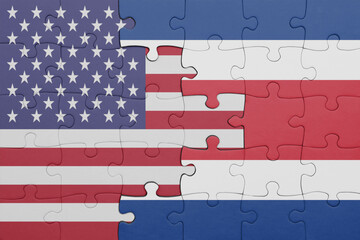 puzzle with the colourful national flag of costa rica and flag of united states of america .