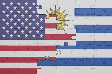 puzzle with the colourful national flag of uruguay and flag of united states of america .