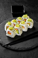 Sesame coated sushi rolls with salmon, avocado and cream cheese