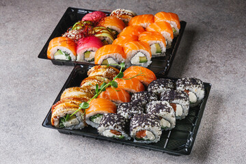 set of delicious fresh sushi roll with salmon avocado cucumber tuna eel Philadelphia cheese