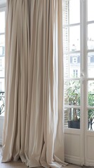 apartment, accentuated by white walls, large windows, and elegant beige curtains framing two sliding doors.