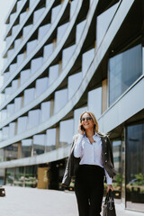 Business professional walking outside modern office building on a sunny day