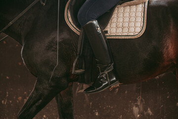 Close-up of rider's boot on horseback.