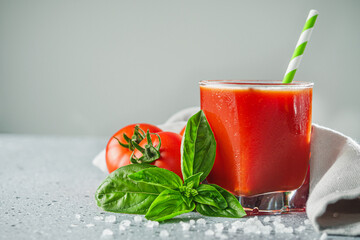 fresh tasty natural tomato juice on a light stone background
