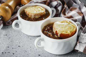 delicious original French onion soup on a light stone background