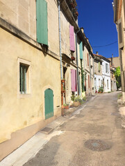narrow small street with old houses in typical architecture style in Arles, France
