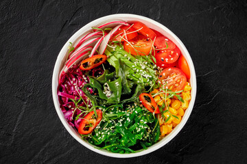 Colorful vegan poke bowl with vegetables, seaweed, and sesame