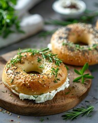 Fresh Bagels with Cream Cheese and Herbs on Wooden Cutting Board