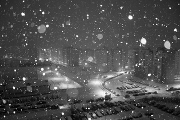 Snowflakes at night city. Black and white style.
