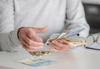 Naklejka premium Elderly Woman'S Hands Count Money, Euros, In Close-Up View