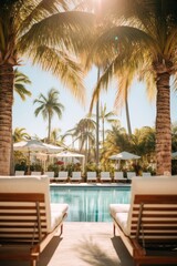 Fototapeta premium Blurred pool area with lounge chairs and palm trees