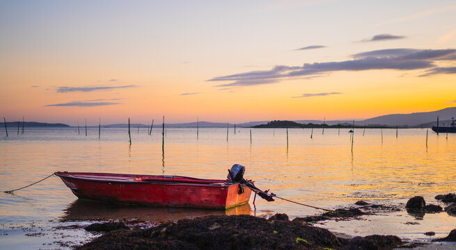 Golden Hour Majesty: Sunrise of a boat in the seashore