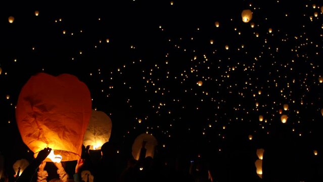 Beautiful wide shot of chinese lanterns being released into sky