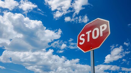 A "STOP" sign against a blue sky background.