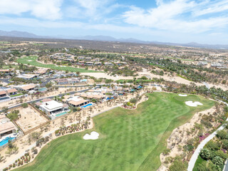 Fototapeta premium Aerial view of luxury golf course on the pacific ocean in Los Cabos, Cabo San Jose, Mexico