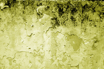 Grungy dirty plaster wall with peeling paint. Yellow color style.