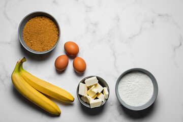 Baking banana bread, ingredients on marble background