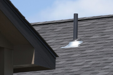 Duplex home rooftop ventilation pipe.
