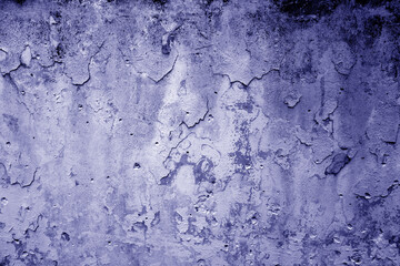Peeling paint on grungy plaster wall. Deep blue color.