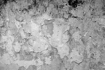 Peeling paint on grungy plaster wall. Black and white style.