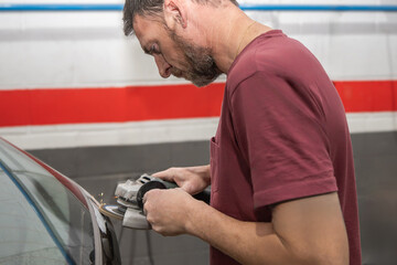 Mechanic Using Grinder on Car in Auto Repair Shop