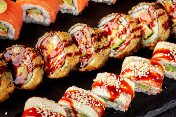 Appetizing crispy tempura rolls with ell and salmon uramaki