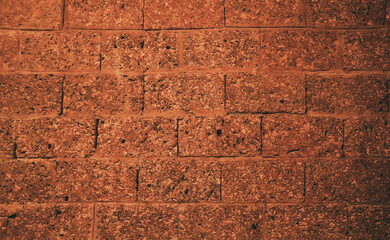 Empty old red grain stone brick wall made with blocks for abstract background and texture....