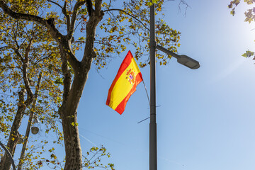 Spanish flag waving in the sky. National flag of Spain, with naval ensign.