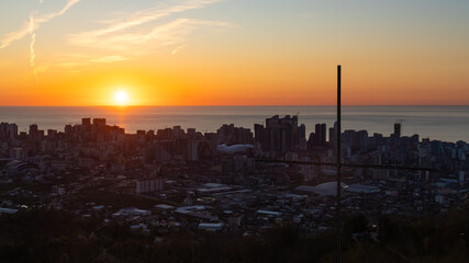 Naklejka premium Panoramic view of Batumi and the sea from the top of the cable car at sunset. Stunning view of the city at sunset, Batumi.