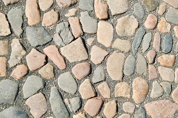 Abstract background of cobblestone pavement. Stone pavement texture.