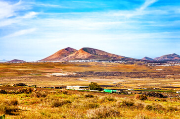 Obraz premium Volcanic landscape with a village, Island Lanzarote, Canary Islands, Spain, Europe.