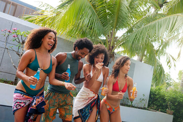 Group of happy young people enjoying, smiling and having fun in a tropical environment.