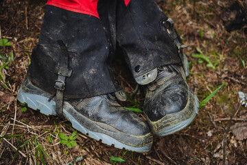 Person in muddy boots and gaiters enjoying outdoor recreation