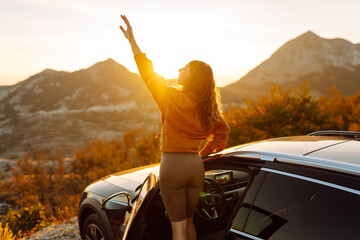 Young woman tourist on road, enjoying window view and traveling  on holiday road trip. Travel...