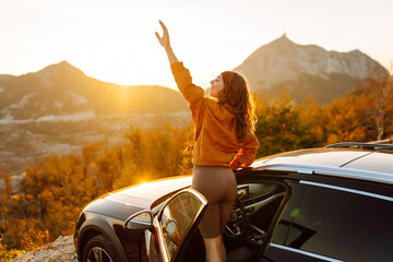 Young woman tourist on road, enjoying window view and traveling  on holiday road trip. Travel...