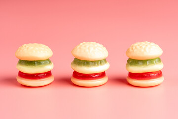 Colorful candy hamburgers on pink background. Minimal food concept.