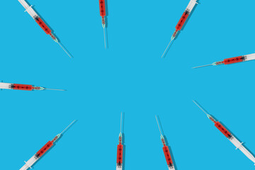 Creative layout made with a syringe on pastel blue background. Minimal Coronavirus outbreak....