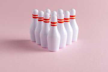 White skittles on pastel pink background. Minimal creative concept.