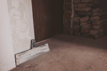 workplace. working with spackling. Damaged wall repair. putty knife on gray grunge cement wall...
