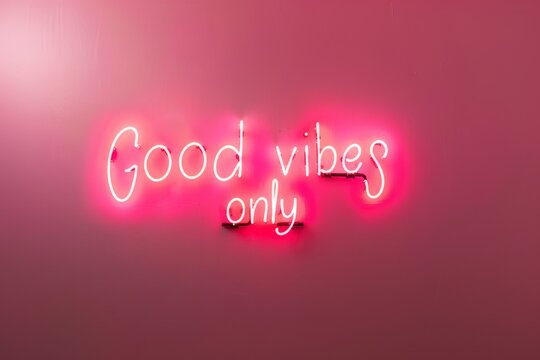 Neon words handwriting on the pink wall. Good vibes only neon sign at the bar, cafe or at home.