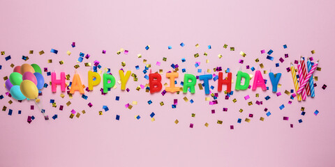 Colorful celebration background with various party confetti and candle decoration. Minimal birthday...