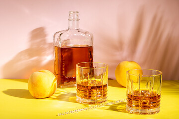 Rum or Amaretto sour with ice in a glass on a bright background. Summer party concept.