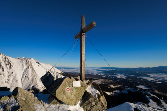 Predne Solisko, High Tatras, Vysoke Tatry, Slovakia. Christian cross on the top, peak and summit of the mountain. Landscape and regious monument and landmark. Evening light, sunny day.