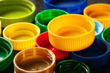 Plastic caps. Multi-colored plastic caps. Plastic recycling. Selective focus