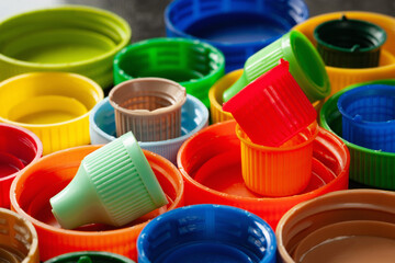 Plastic caps. Multicolored plastic lids. Plastic recycling. Selective focus