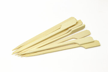 Pile of sharp bamboo sticks isolated on white background. Wooden cocktail and snack sticks