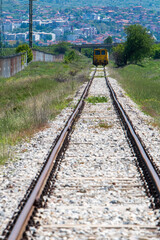 Obraz premium Mirage or Reality. The Enigmatic Perspective of an Approaching Yellow Train Locomotive on the Railroad.